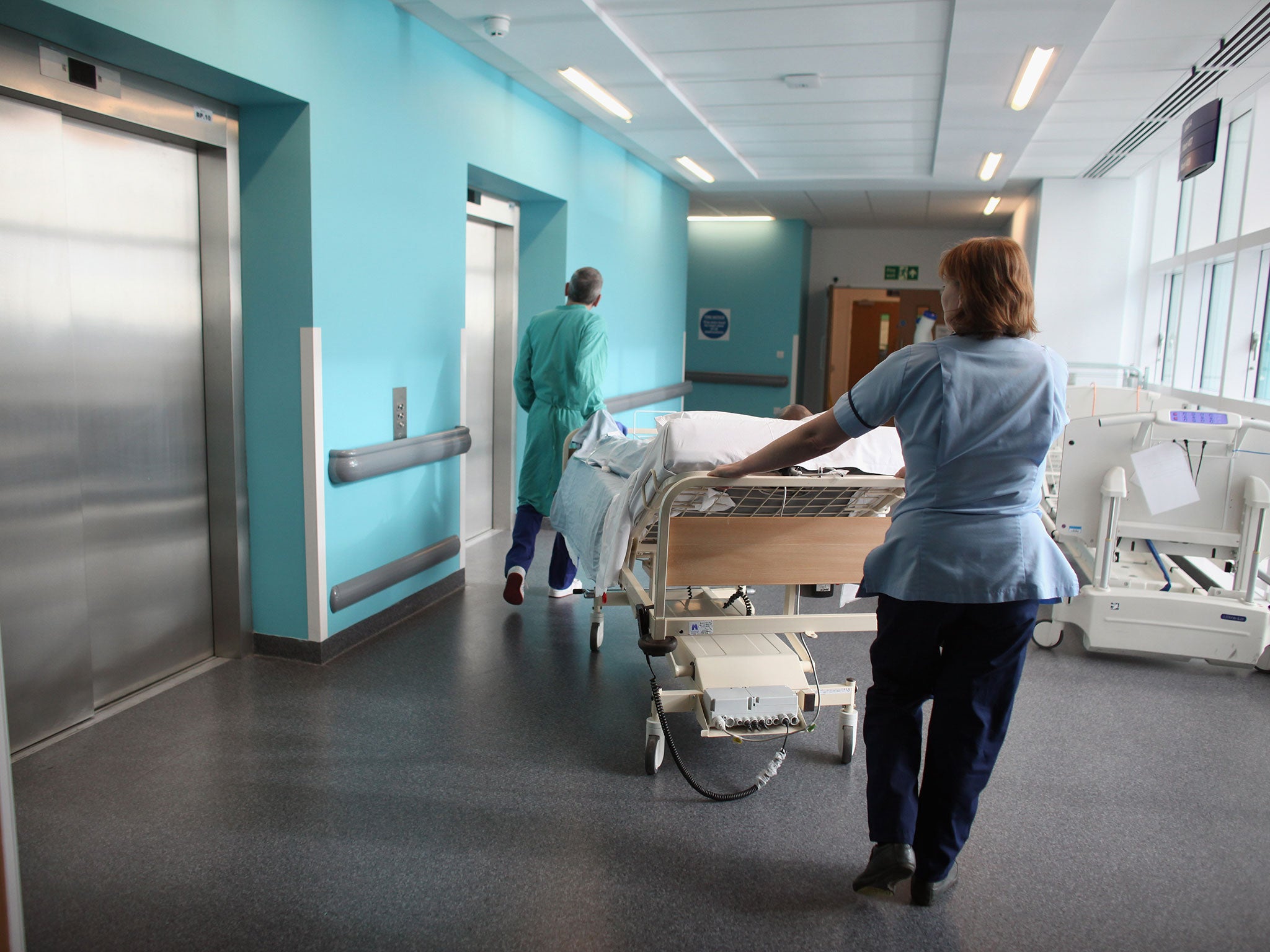 A patient is taken to the operating theatre at Birmingham Queen Elizabeth Hospital