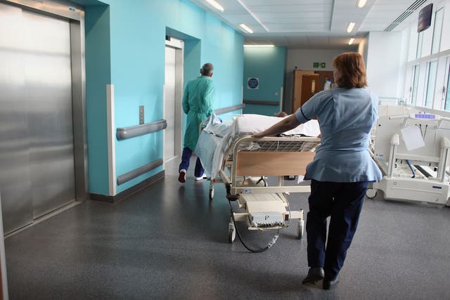 A patient is taken to the operating theatre at Birmingham Queen Elizabeth Hospital