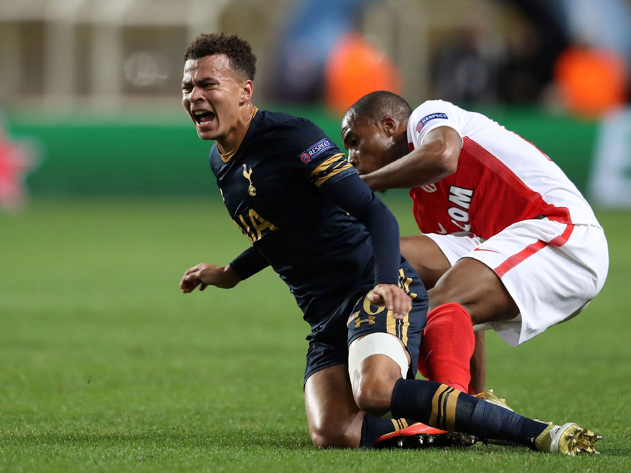 Dele Alli feels the full force of the Monaco defence