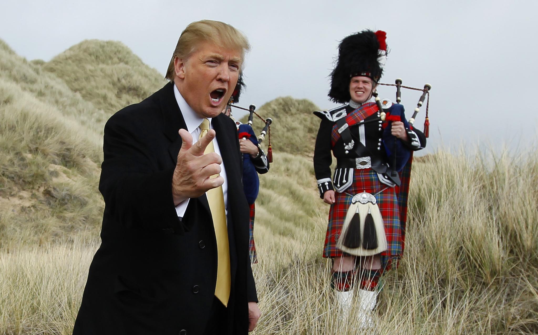 U.S. property mogul Donald Trump gestures during a media event on the sand dunes of the Menie estate, the site for Trump's proposed golf resort, near Aberdeen, north east Scotland May 27, 2010