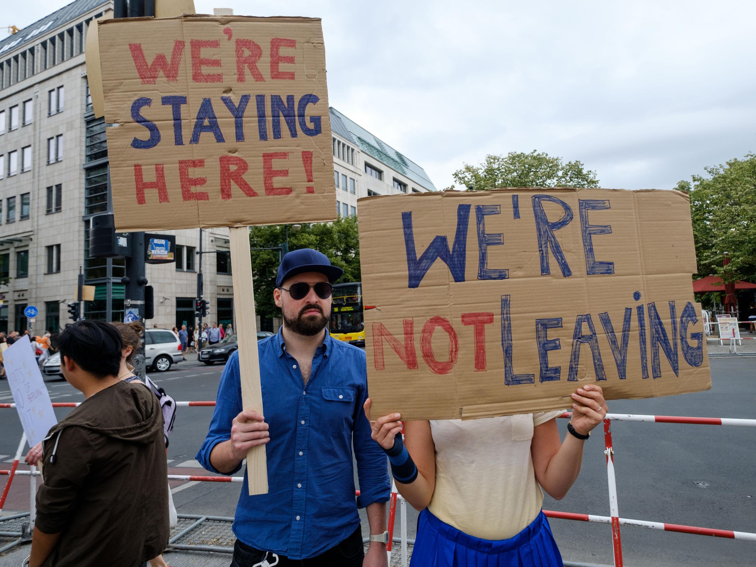 British expats hold up signs to protest Brexit