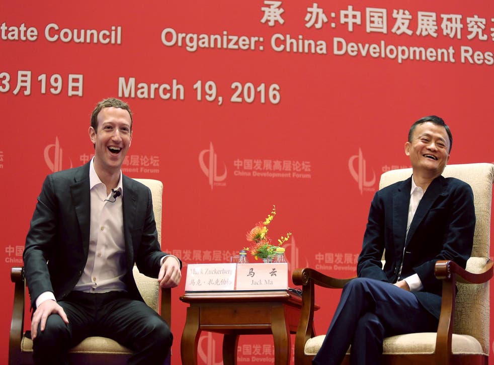 Facebook founder and CEO Mark Zuckerberg and Founder and Executive Chairman of Alibaba Group Jack Ma laugh as they meet at the China Development Forum in Beijing, China, March 19, 2016