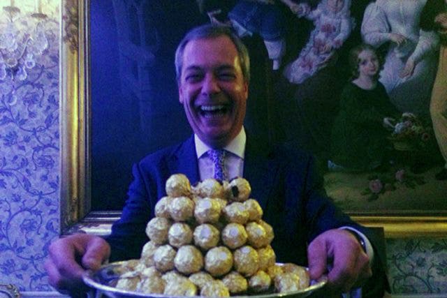 Nigel Farage holds a platter of Ferrro Rocher chocolates during a party in London