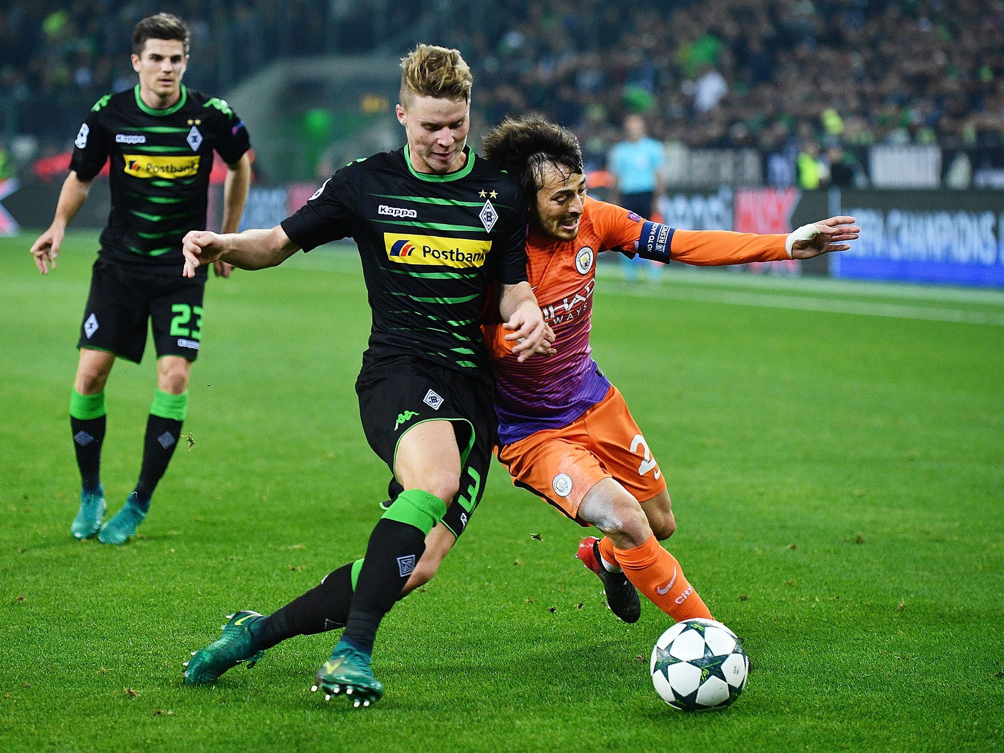 David Silva and Nico Elvedi go shoulder-to-shoulder as they compete for the ball