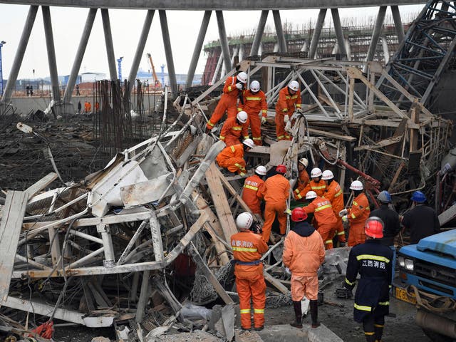 Rescue workers look for survivors after a work platform collapsed at the Fengcheng power plant in eastern China's Jiangxi Province