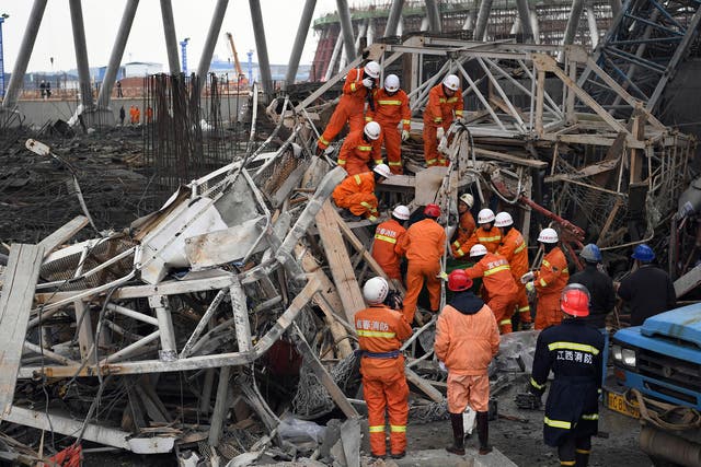 Rescue workers look for survivors after a work platform collapsed at the Fengcheng power plant in eastern China's Jiangxi Province