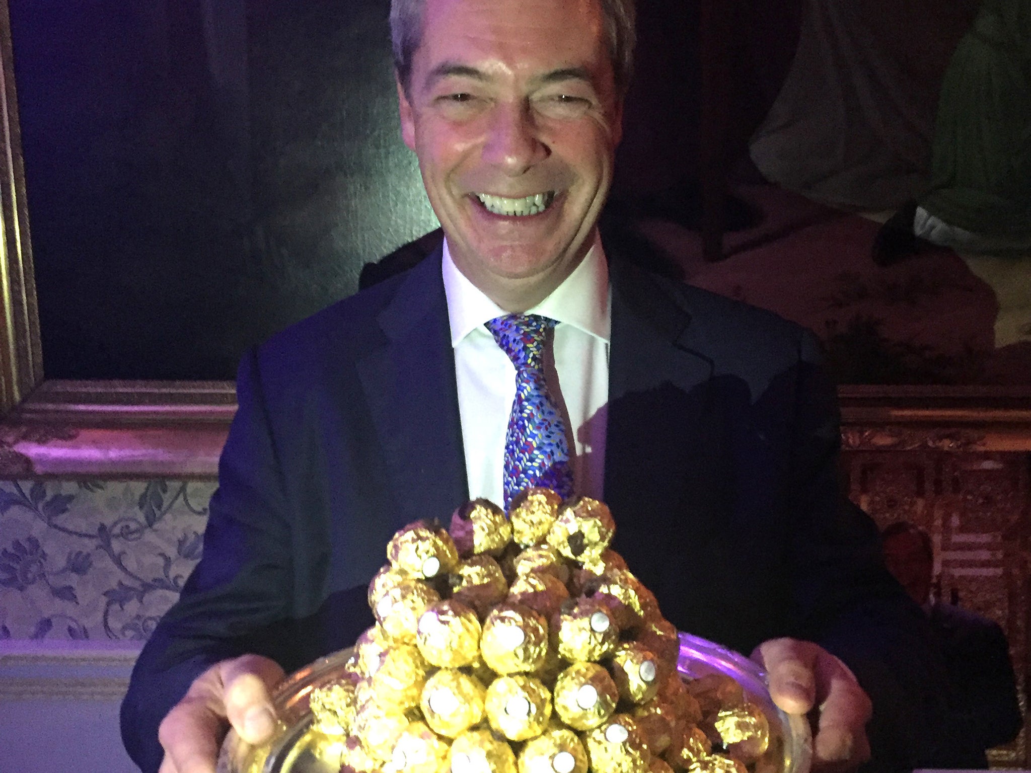Nigel Farage is presented with a tray of Ferrero Rocher chocolates at an event to thank him for his contribution to Brexit