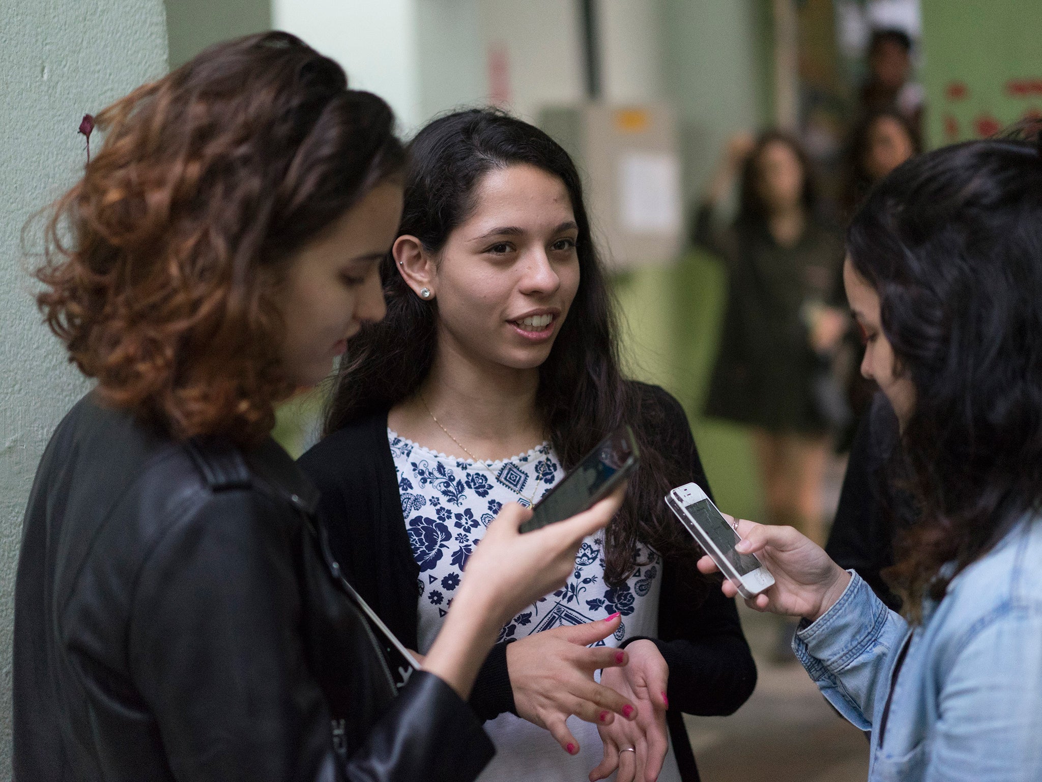 Ana Julia Pires Ribeiro, center, talks with students at the Colegio Pedro II school