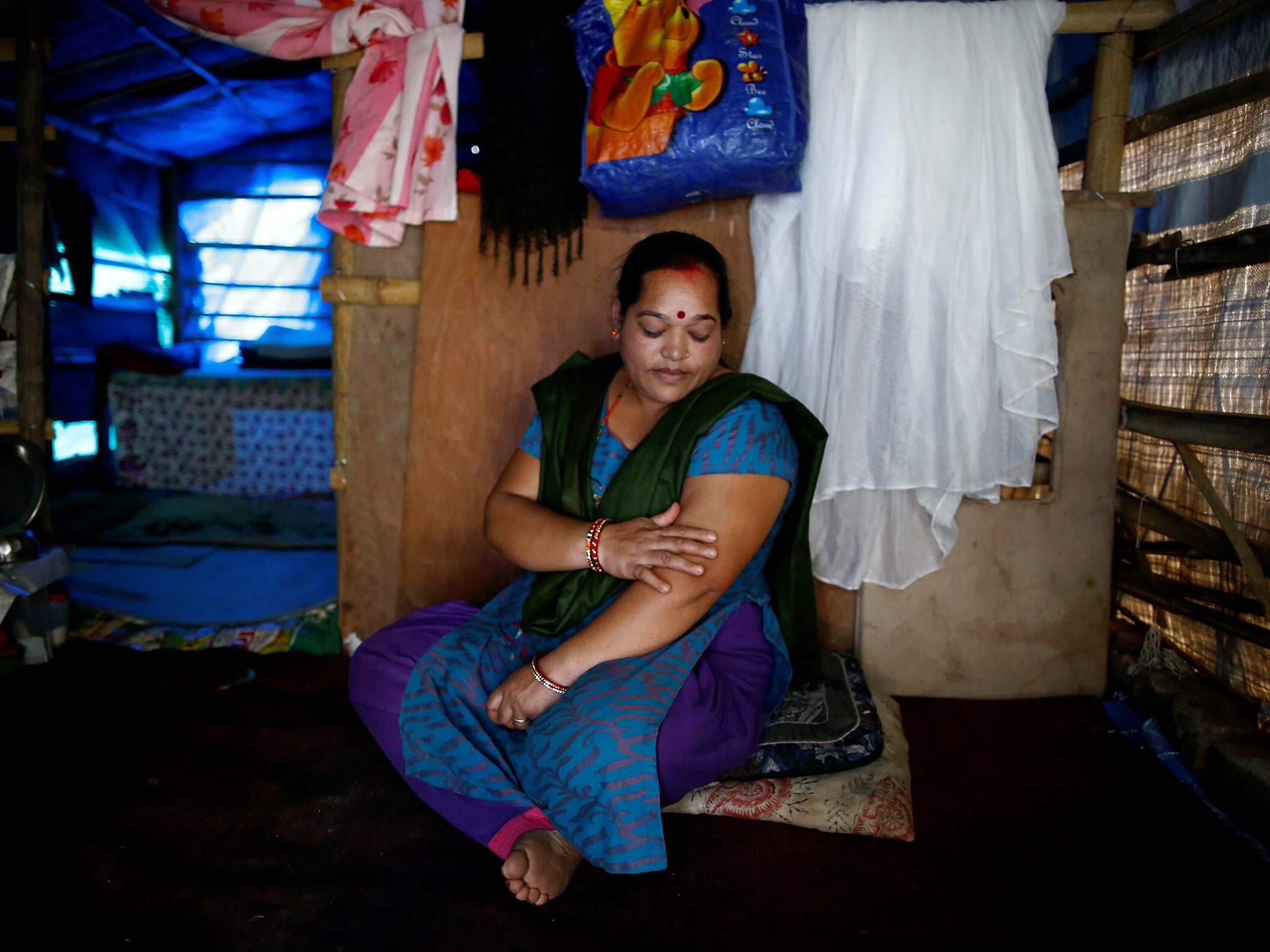 Shanti Pariyar, 42, sits inside her makeshift shelter