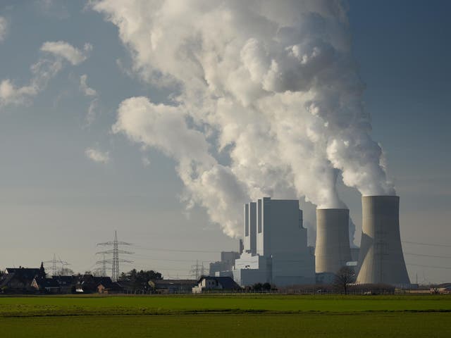 Steam rises from cooling towers of a coal-fired power plant