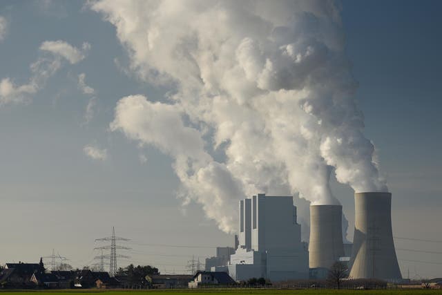 Steam rises from cooling towers of a coal-fired power plant