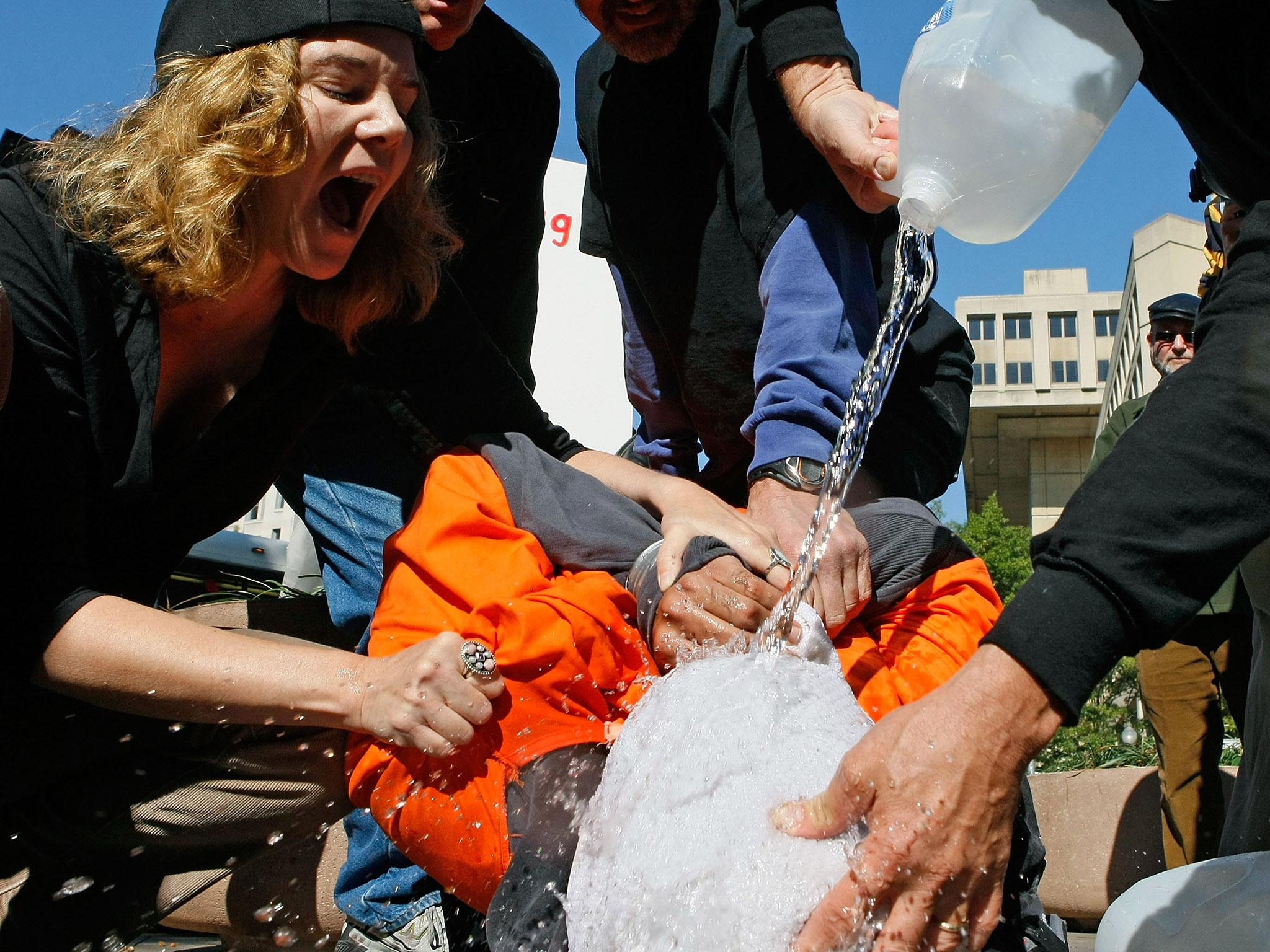 Activists demonstrate waterboarding in front of the Justice Department