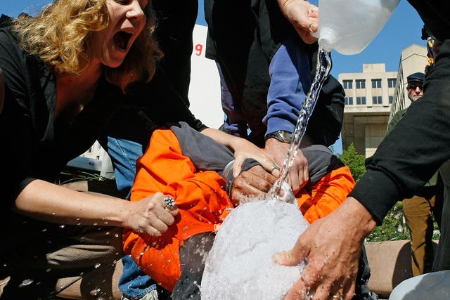 Activists demonstrate waterboarding in front of the Justice Department