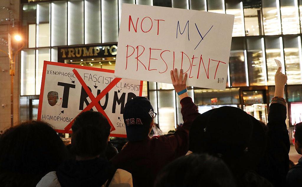 Dozens of anti-Donald Trump protesters stand along 5th Avenue in front of Trump Tower as New Yorkers react for a second night to the election of Trump as president of the United States on November 10, 2016 in New York City. Trump defeated Democrat Hillary Clinton to become the 45th president.