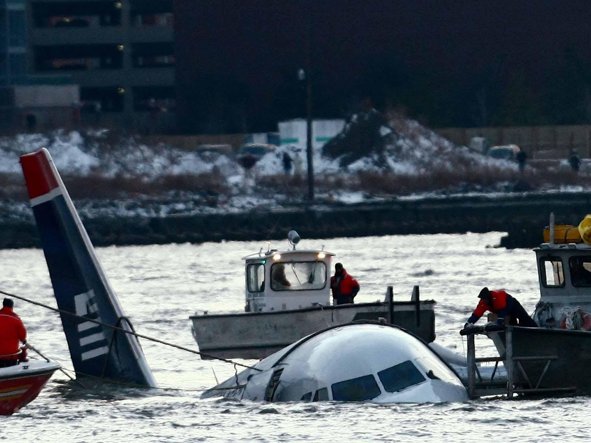Rescue crews secure a US Airways flight 1549 floating in the water after it crashed into the Hudson River in 2009