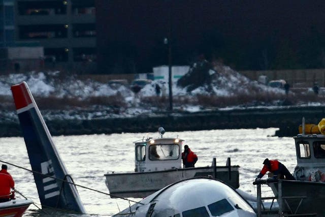 Rescue crews secure a US Airways flight 1549 floating in the water after it crashed into the Hudson River in 2009