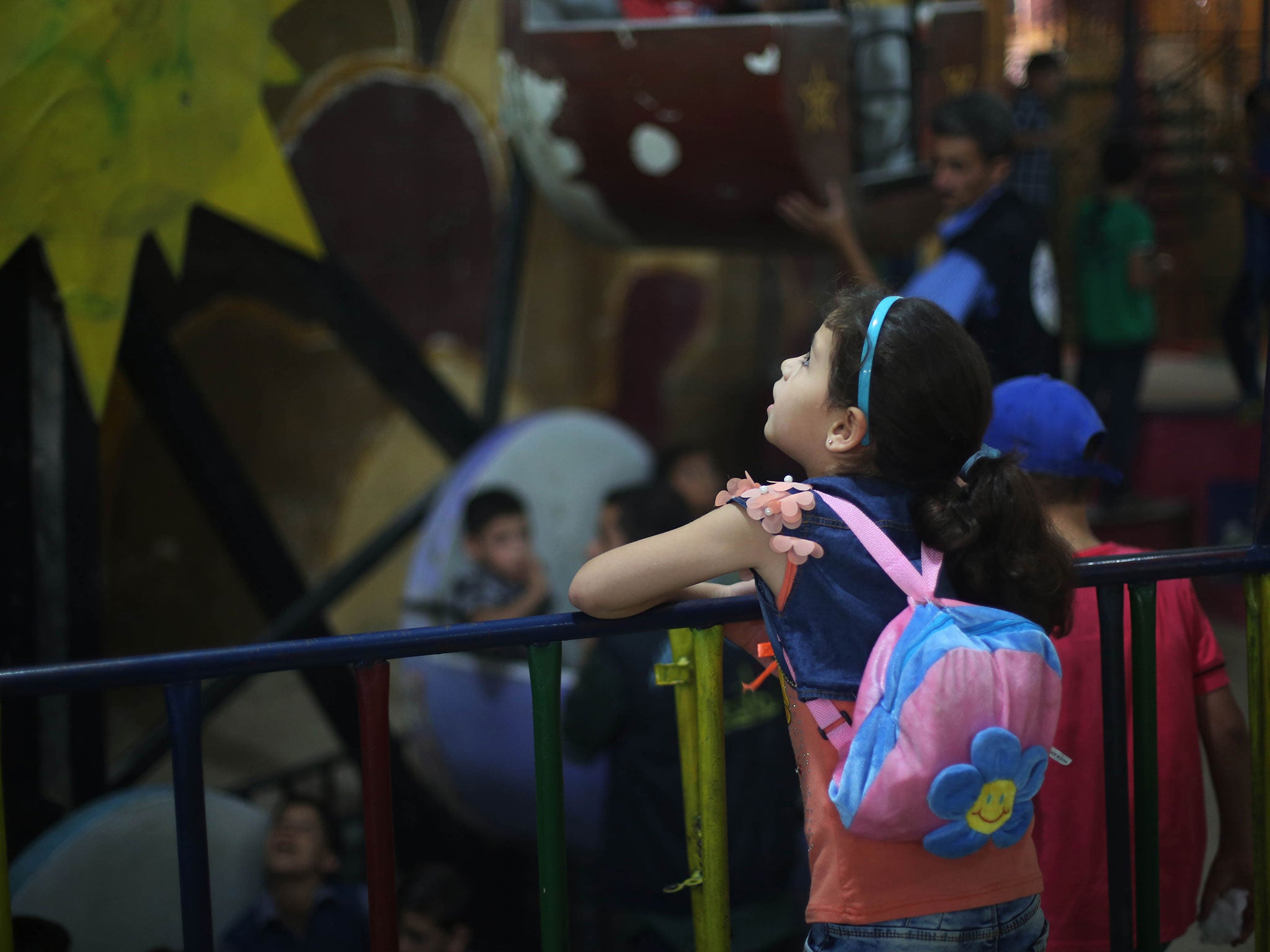 Seven-year-old Massa at the "Land of Childhood" underground playground in a besieged town in Syria