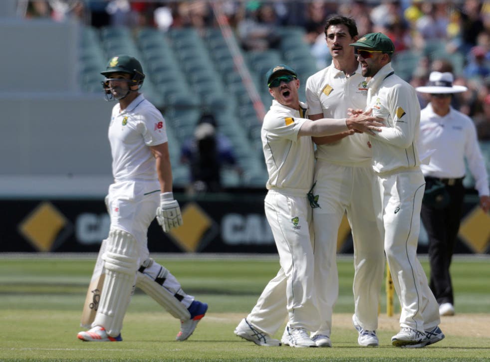 South Africa's Dean Elgar (L) walks off the pitch after being dismissed for no runs off the bowling of Australia's Mitchell Starc (2nd R) as team mates David Warner (3rd L) and Nathan Lyon celebrate during the third day of the Third Test cricket match in Adelaide