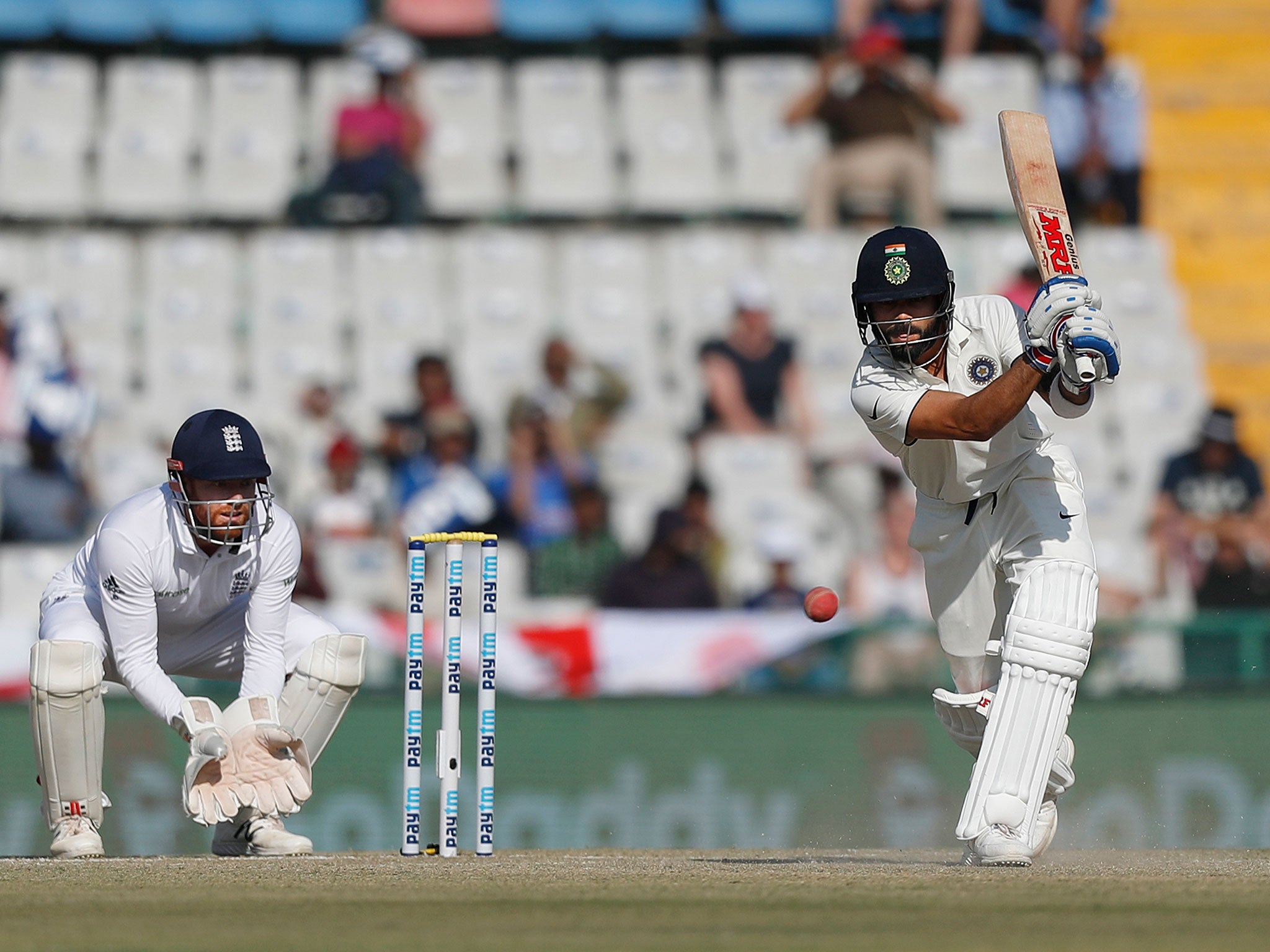 India's captain Virat Kohli plays a shot on the second day of their third cricket test match against England in Mohali