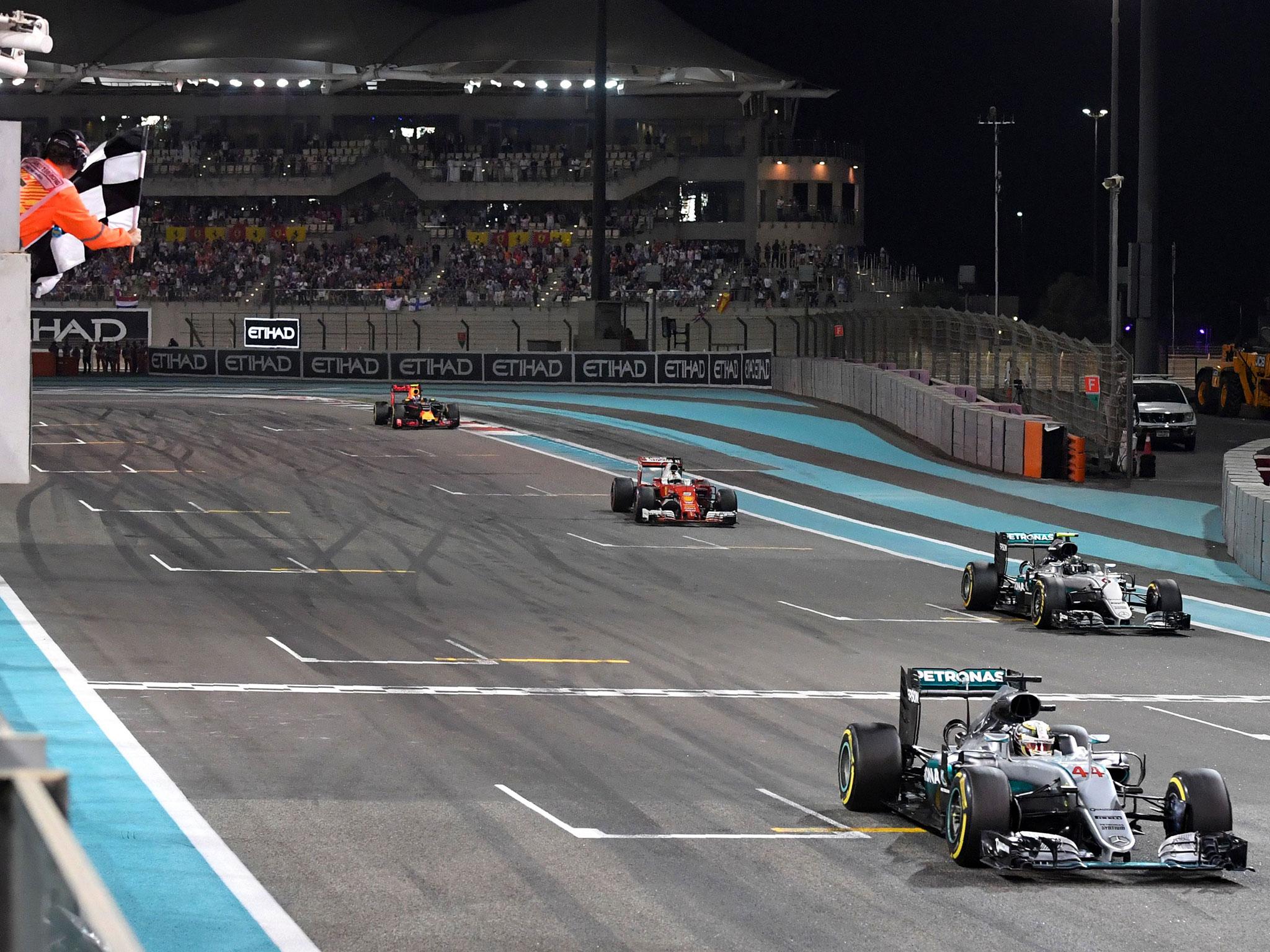 Lewis Hamilton crosses the line to win the Abu Dhabi Grand Prix as Nico Rosberg wins the world championship