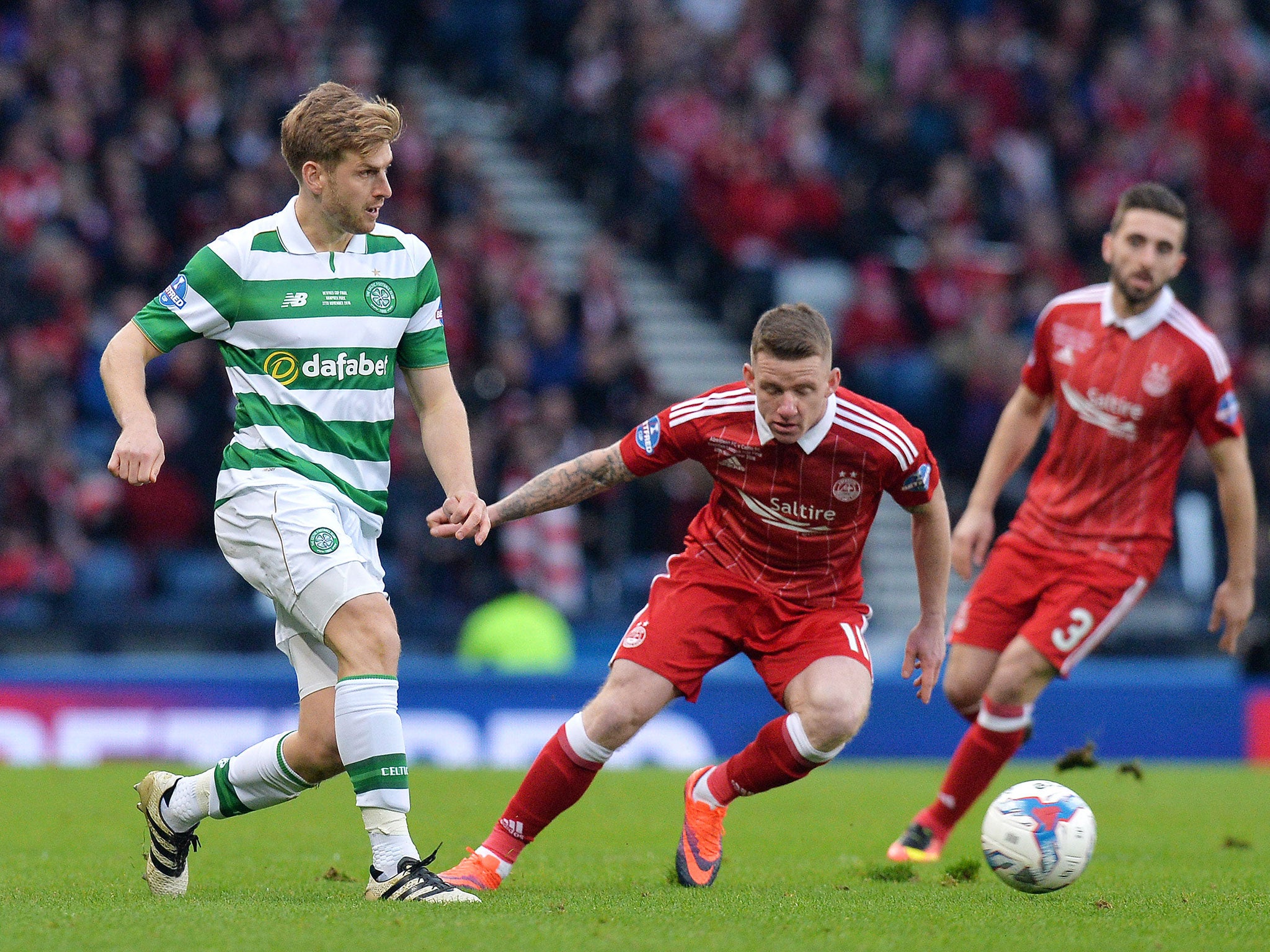 Celtic's Stuart Armstrong looks to get the ball away from Jonny Hayes