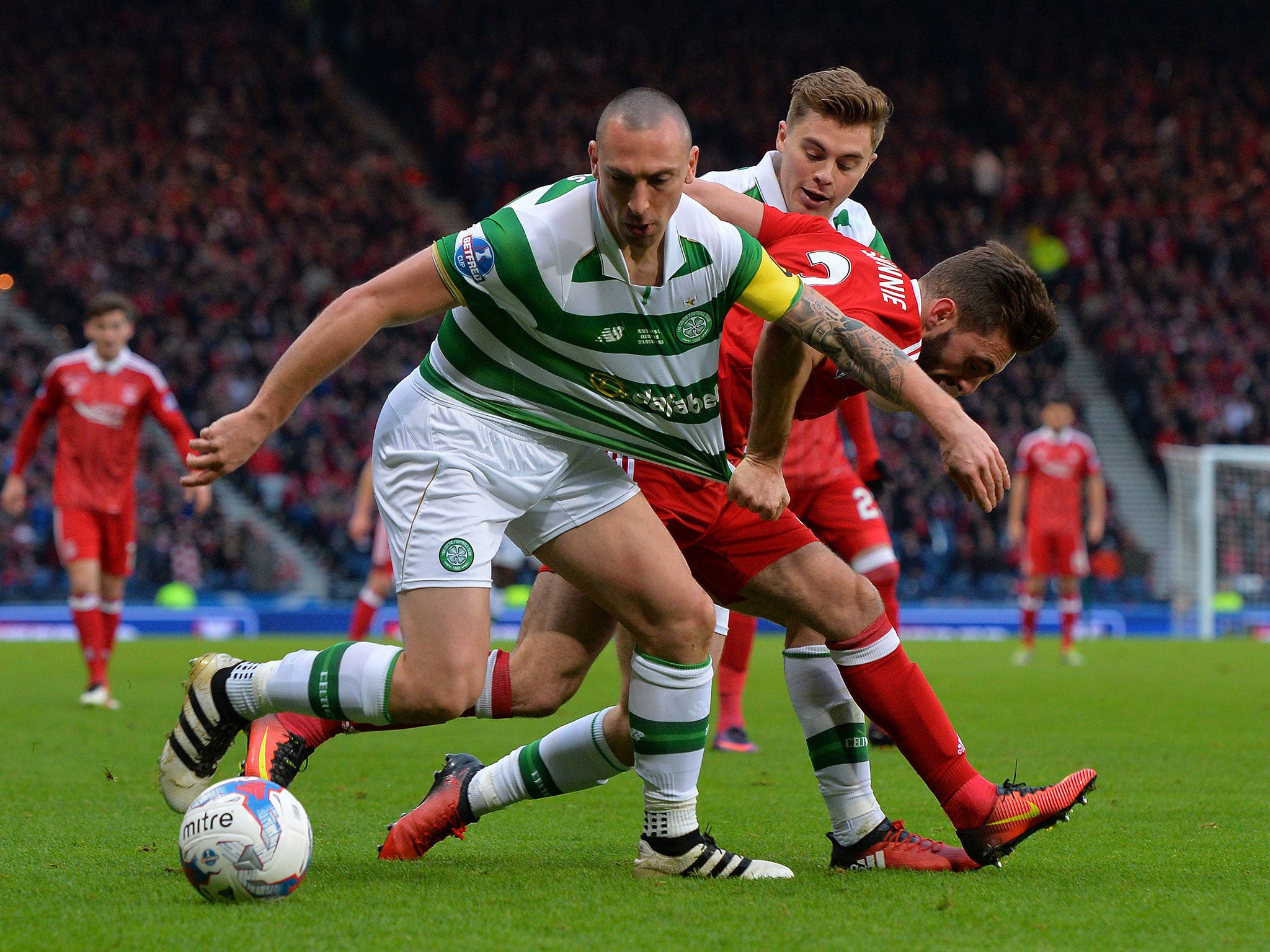 Scott Brown and Graeme Shinnie vie for the ball