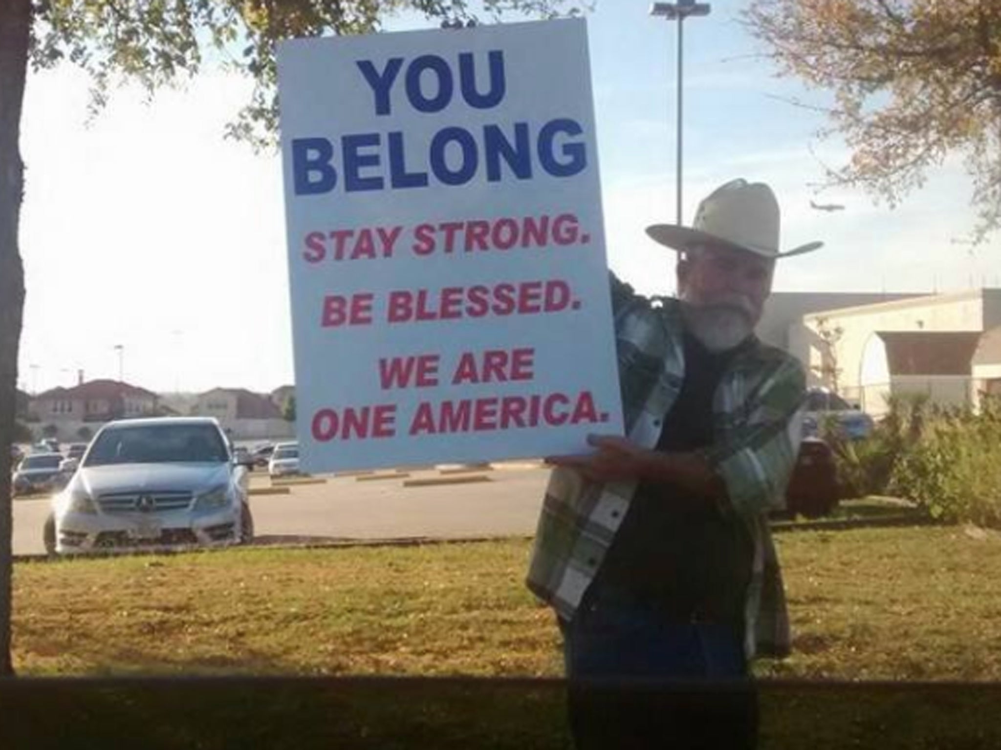 Man pictured outside of the Irvine Mosque in Texas holding sign