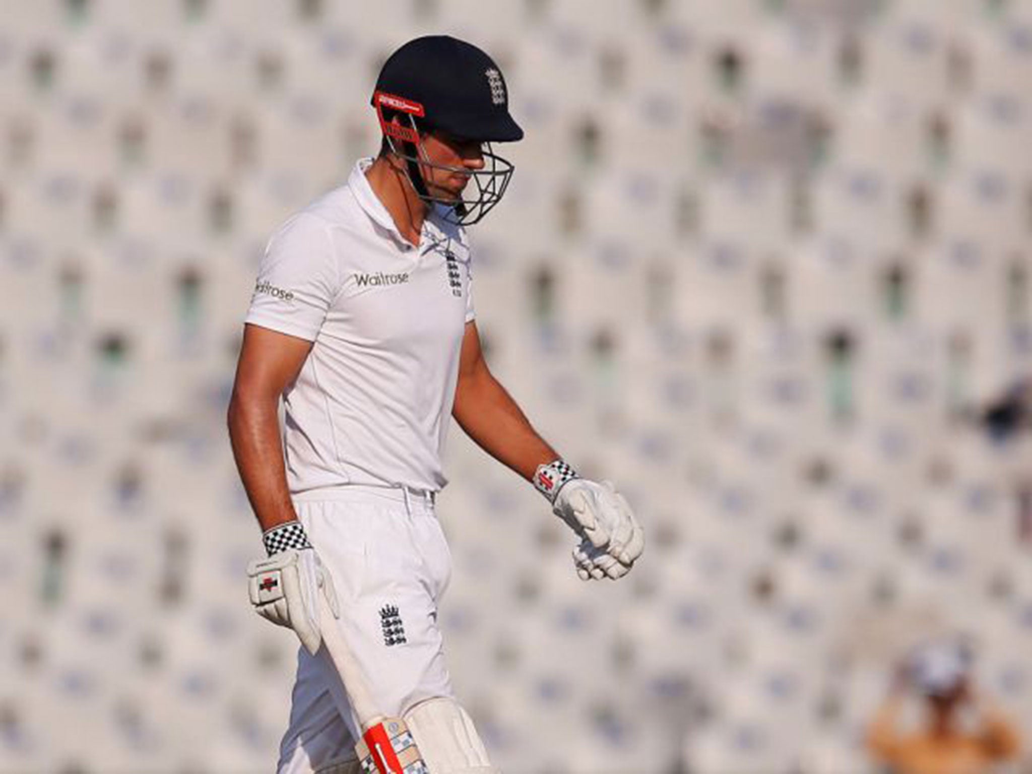 Alastair Cook walks off the pitch after being clean-bowled by Ravichandran Ashwin