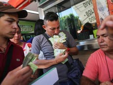Venezuela's currency worth so little shopkeepers weigh piles of notes