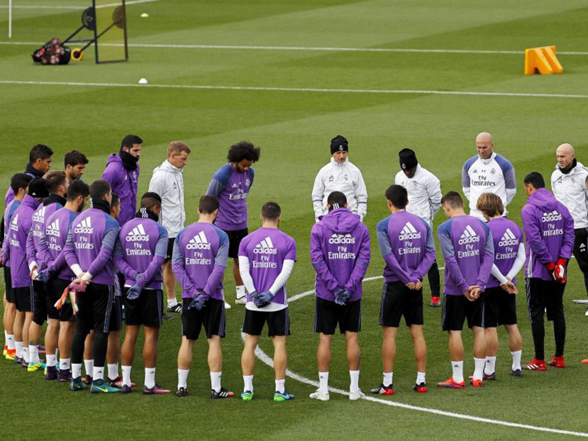 Real Madrid players hold a minute's silence before training in memory of the Colombia plane crash victims