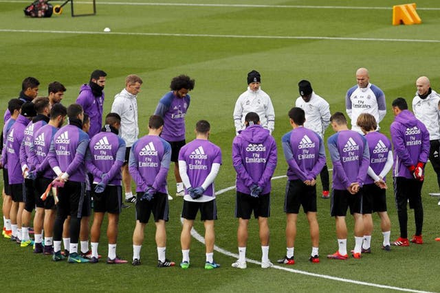 Real Madrid players hold a minute's silence before training in memory of the Colombia plane crash victims