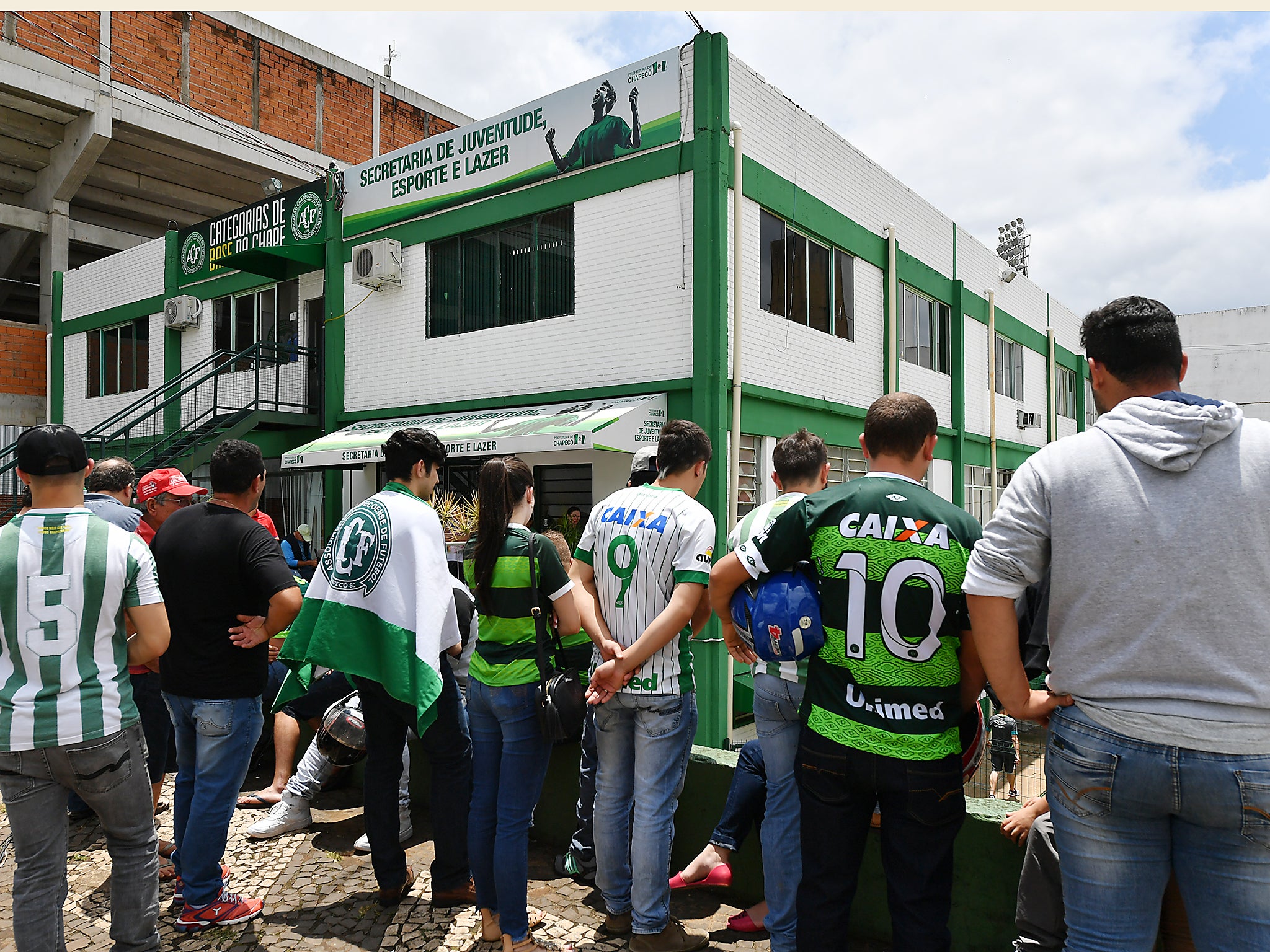 People pay tribute to the players of Brazilian team Chapecoense Real who were killed in a plane accident in the Colombian mountains, at the club's Arena Conda stadium in Chapeco