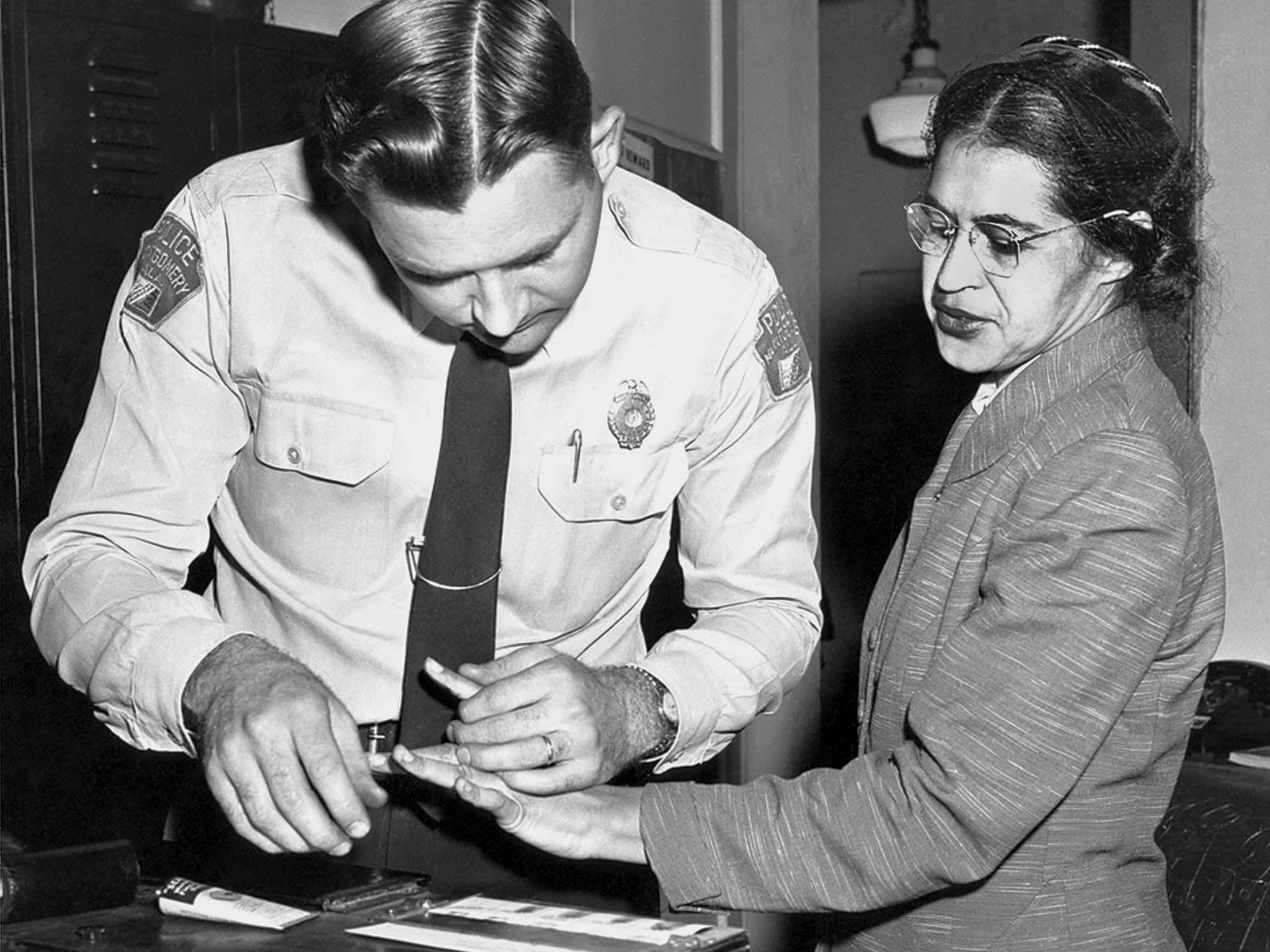 Rosa Parks has her fingerprint taken after refusing to give up her seat on a bus to a white passenger
