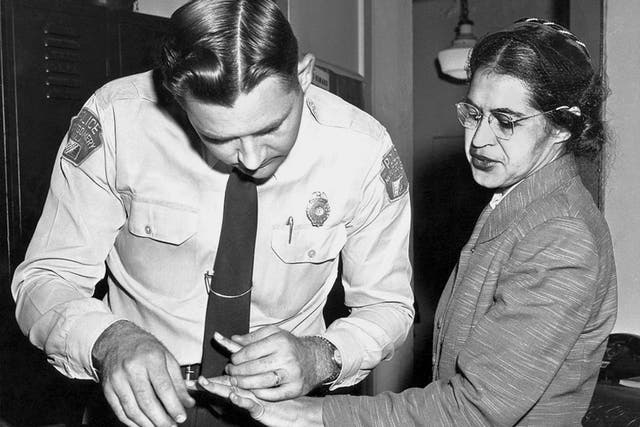 Rosa Parks has her fingerprint taken after refusing to give up her seat on a bus to a white passenger