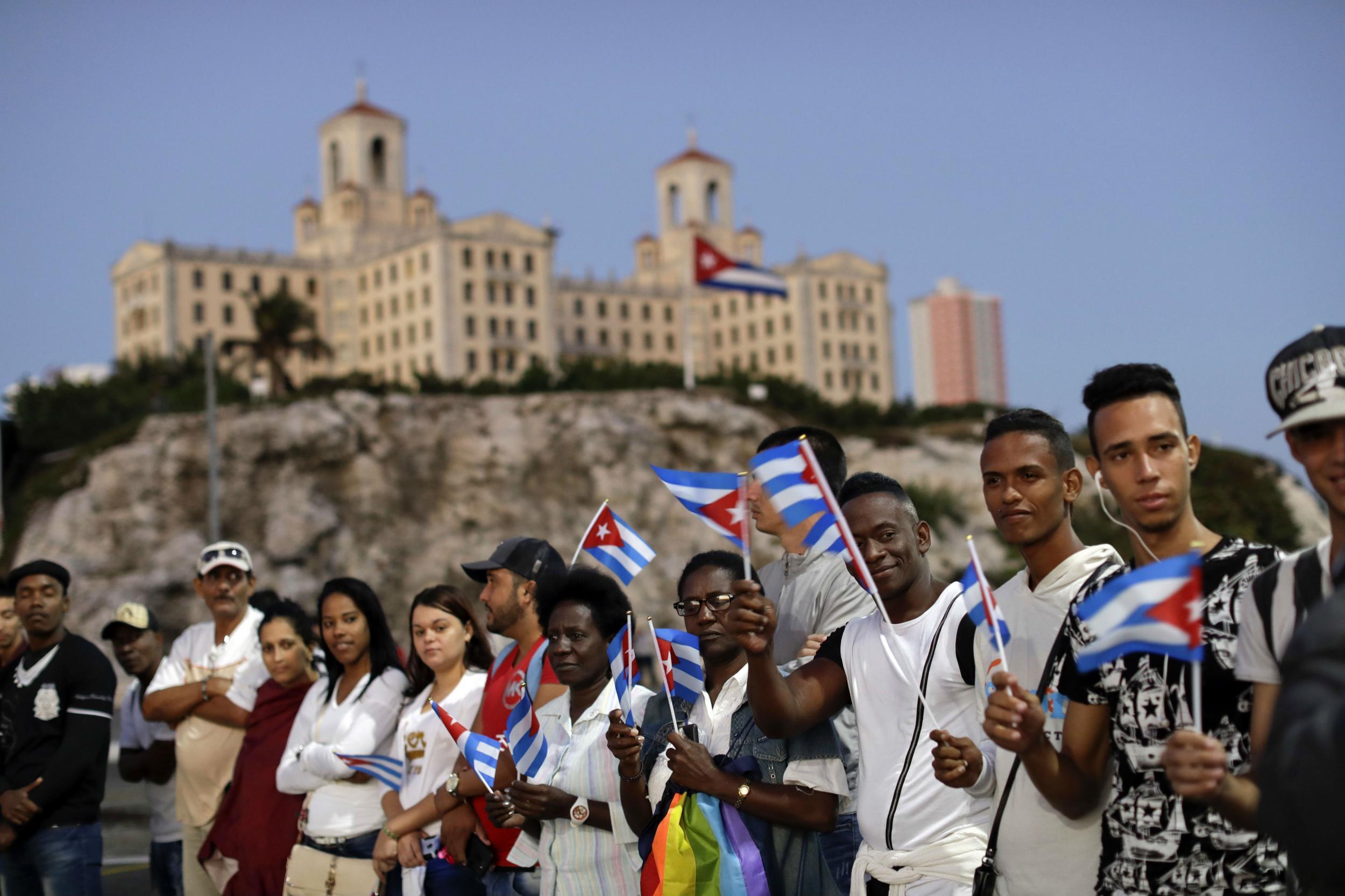 Crowds on the Malecon wait for a glimpse of Castro's coffin beneath the iconic National Hotel