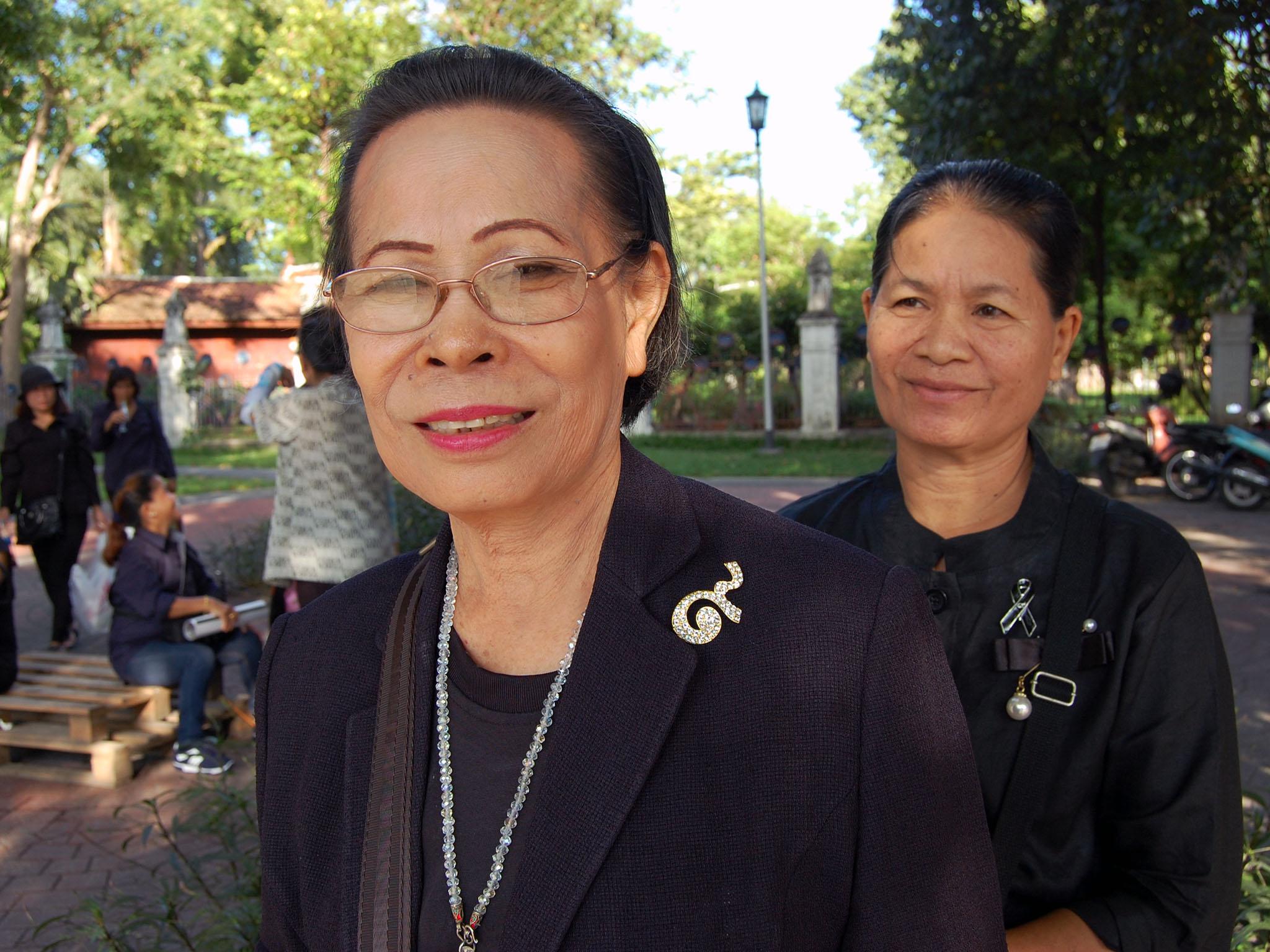 The Thai government asks that residents and visitors either wear black, or wear pins, as seen here, honouring the king