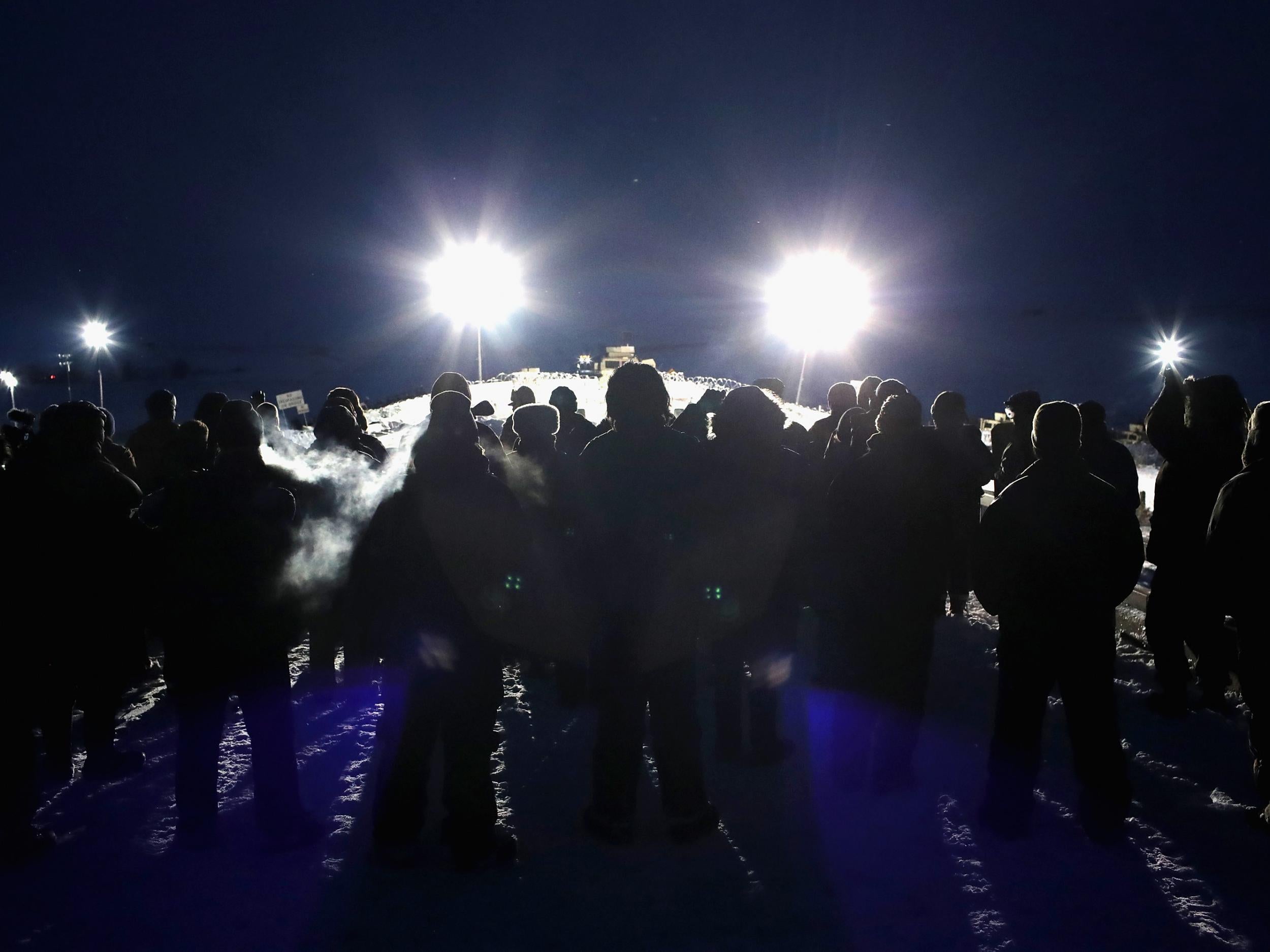 Military veterans, most of whom are native American, confront police guarding a bridge near Oceti Sakowin Camp on the edge of the Standing Rock Sioux Reservation on November 30, 2016 outside Cannon Ball, North Dakota