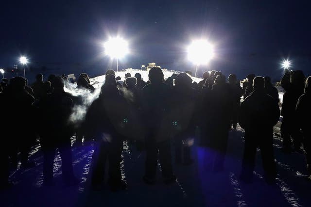 Military veterans, most of whom are native American, confront police guarding a bridge near Oceti Sakowin Camp on the edge of the Standing Rock Sioux Reservation on November 30, 2016 outside Cannon Ball, North Dakota