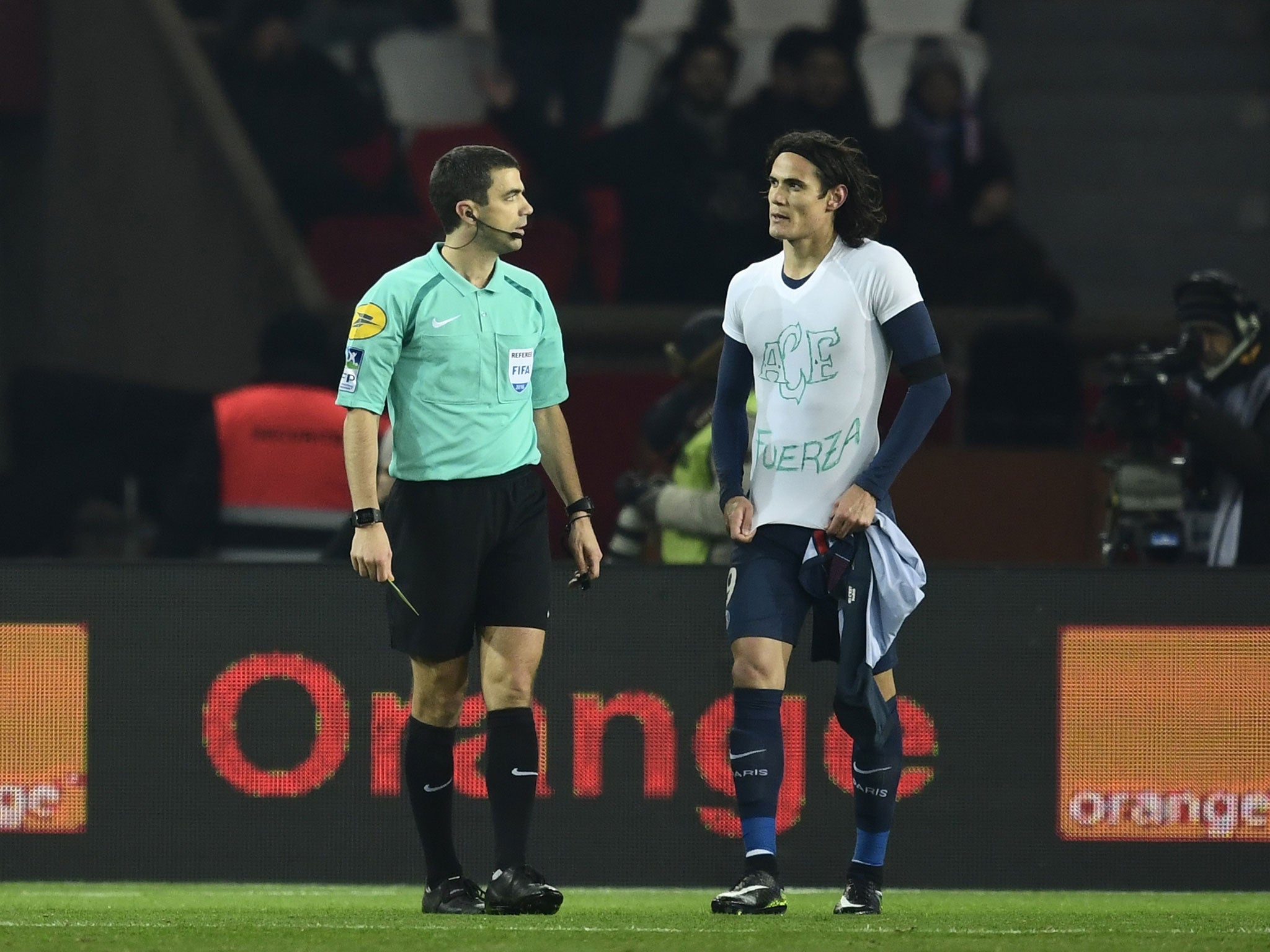 Edinson Cavani was booked by referee Franck Schneider for taking off his shirt
