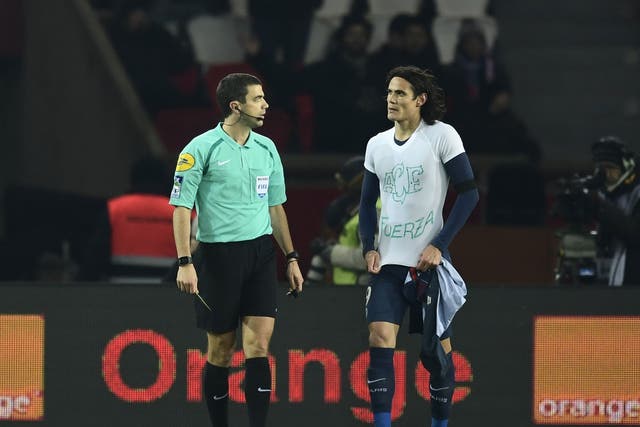 Edinson Cavani was booked by referee Franck Schneider for taking off his shirt