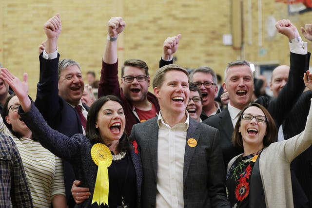Liberal Democrat candidate Sarah Olney with her husband Ben and party supporters celebrate after winning the Richmond Park by-election
