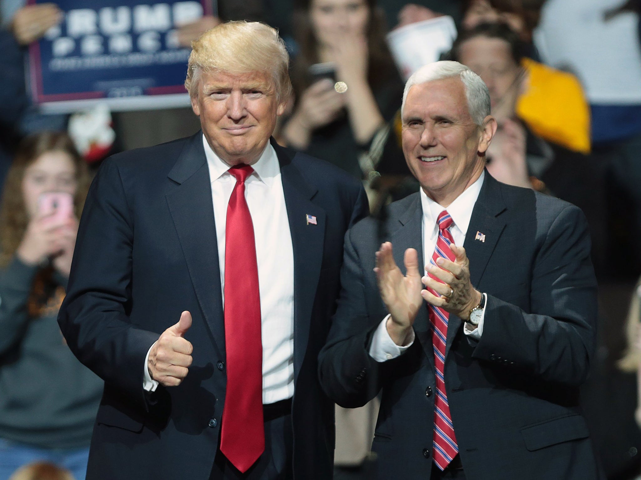 US President-elect Donald Trump stands with his running mate, Vice President-elect Mike Pence