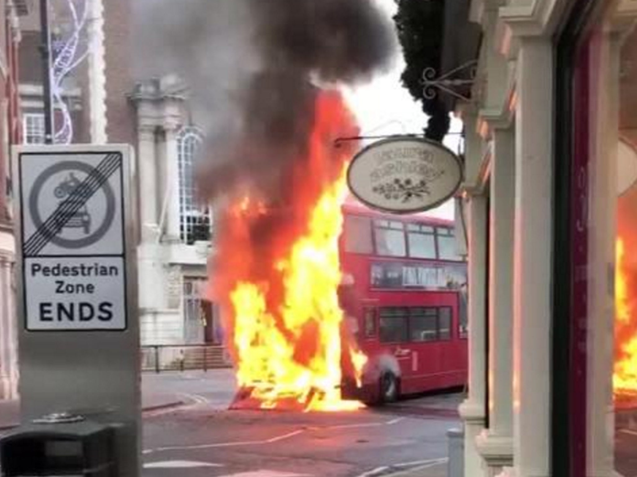 A London bus in flames in Kingston