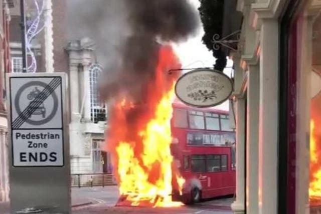 A London bus in flames in Kingston