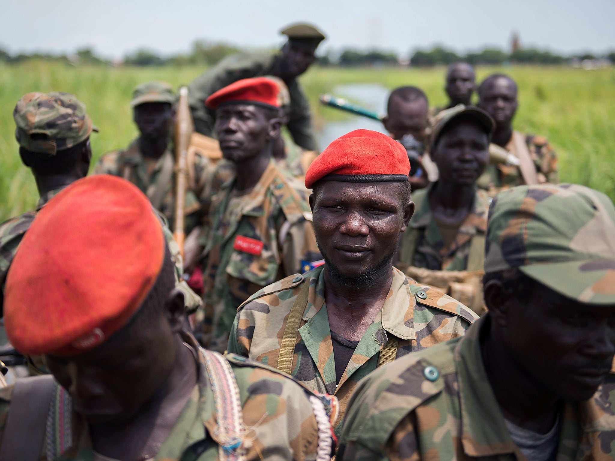 Sudan People Liberation Army (SPLA) soldiers ride on a boat on the Nile River near Alole, northern South Sudan