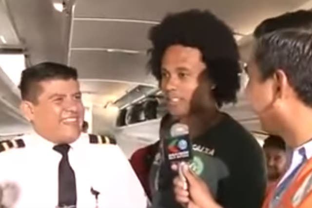 Cabin crew and striker Everton dos Santos Goncalves are interviewed before takeoff
