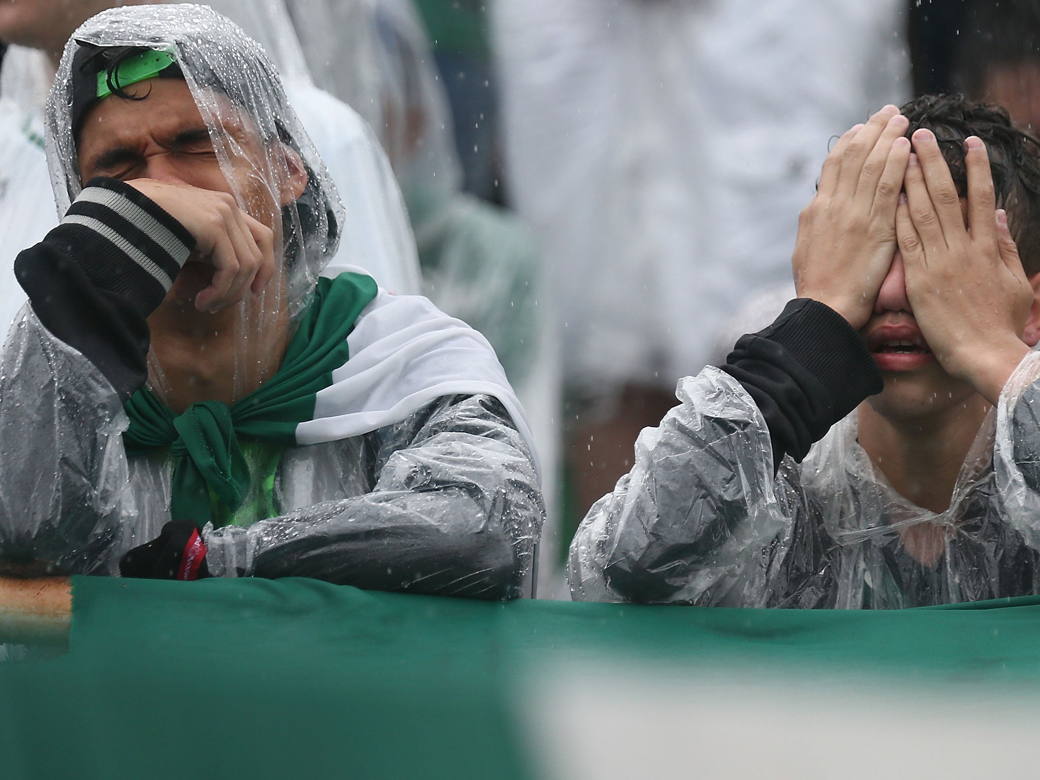 Fans cry while paying tribute to the players of Brazilian team Chapecoense Real at the club's Arena Conda stadium in Brazil on 3 December