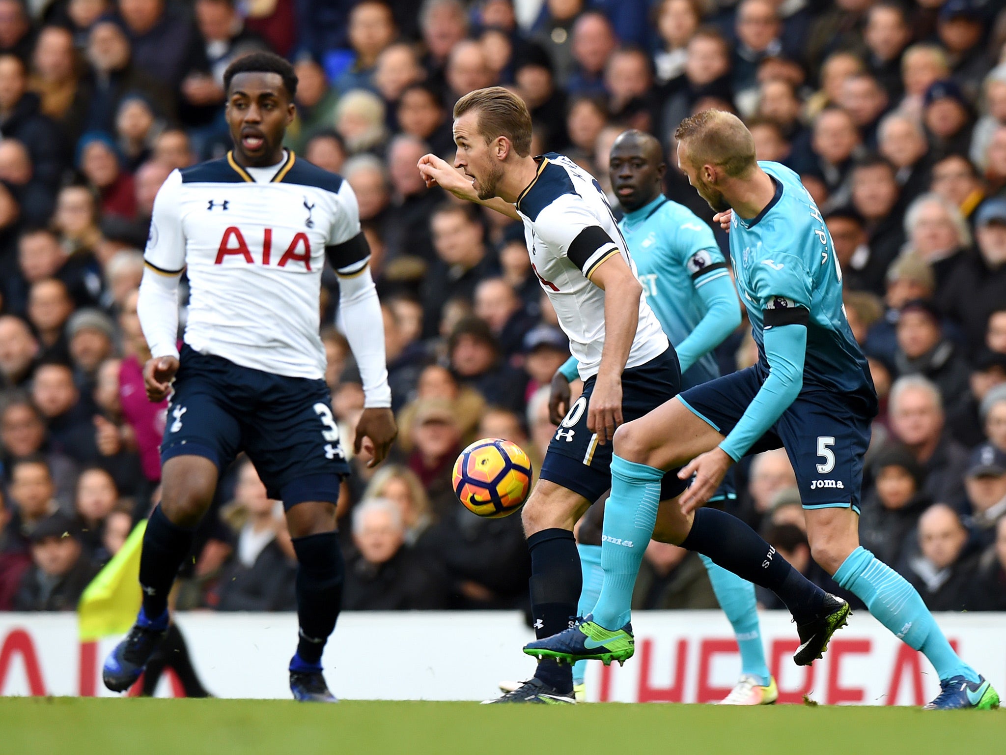 Kane carries the ball forward through Swansea's defences