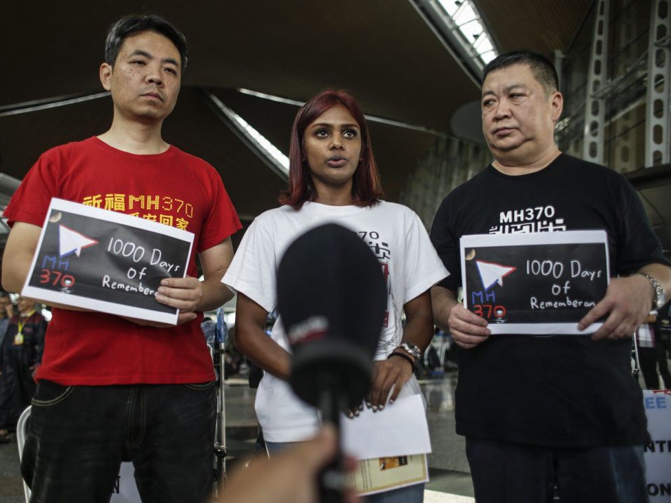 MH370 next-of-kin, Grace Subathirai Nathan of Malaysia (C) and Jiang Hui (L) and Bai Shuan Fu (R) from China attend a press conference at Kuala Lumpur International Airport in Sepang, Malaysia