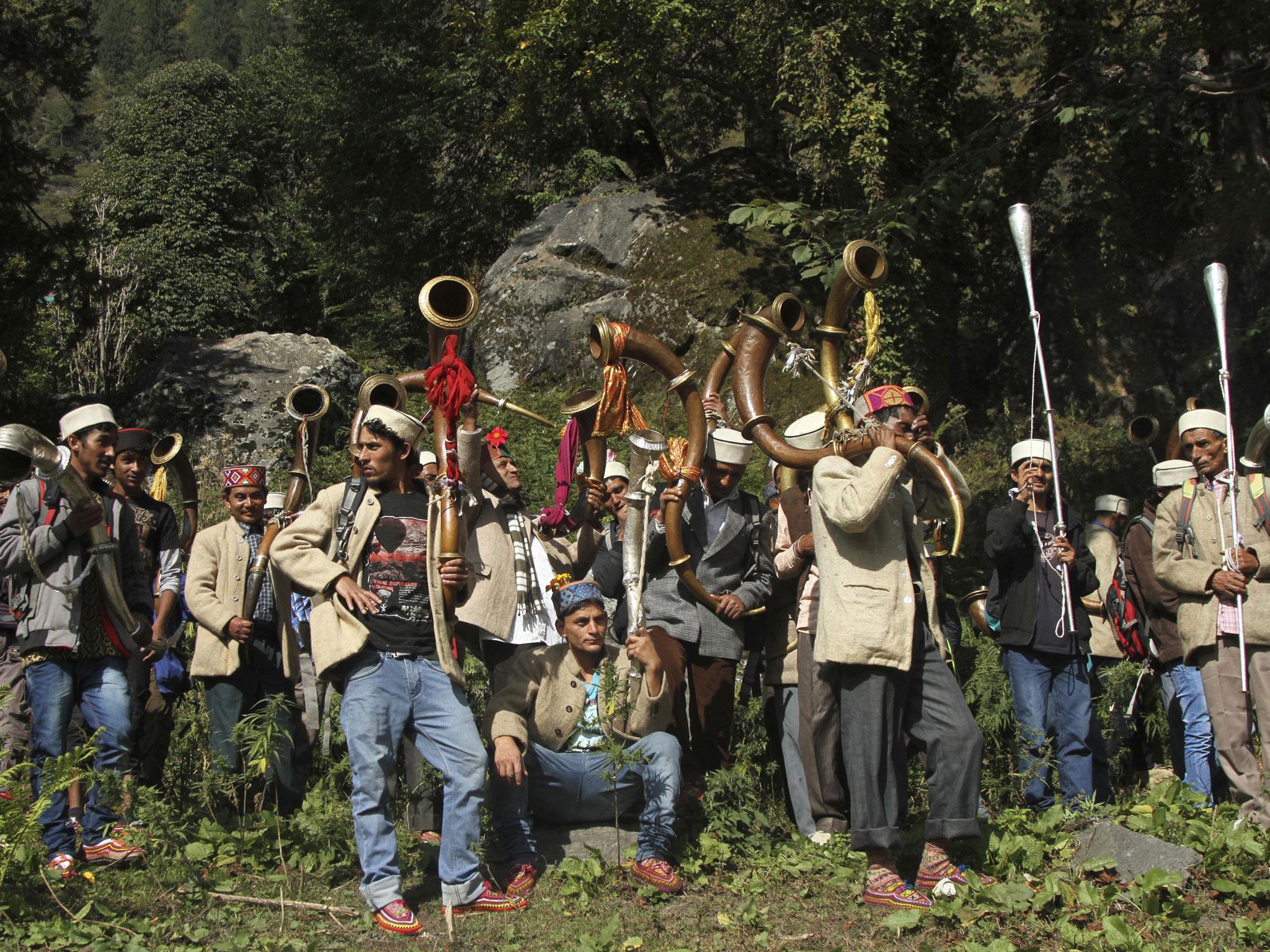 Local villagers prepare to take a statue of the village god Jamlu on a pilgrimage. The journey across the daunting mountain of Rasol is undertaken to bathe the deity in holy water in a temple in the neighboring valley. Its laws, tradition says, were laid down by the village god Jamlu